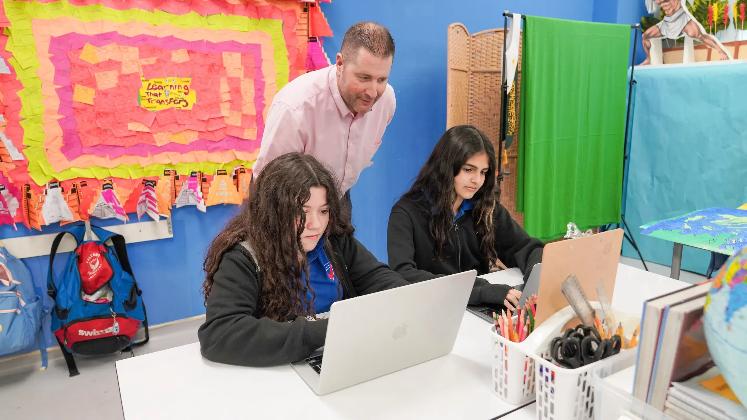 AISJ teacher coaching students during collaborative classroom work