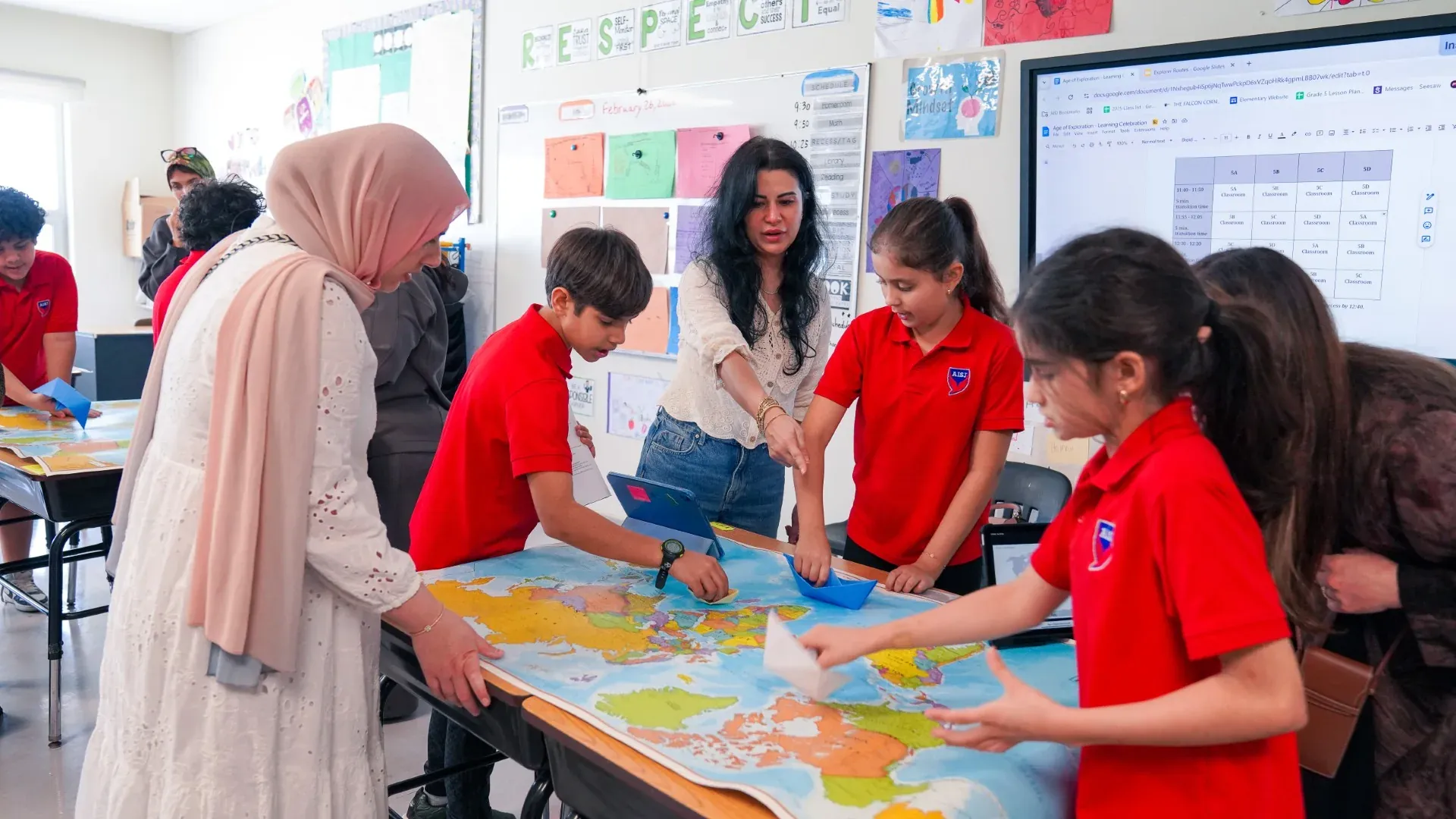 AISJ students collaborating around a classroom map activity