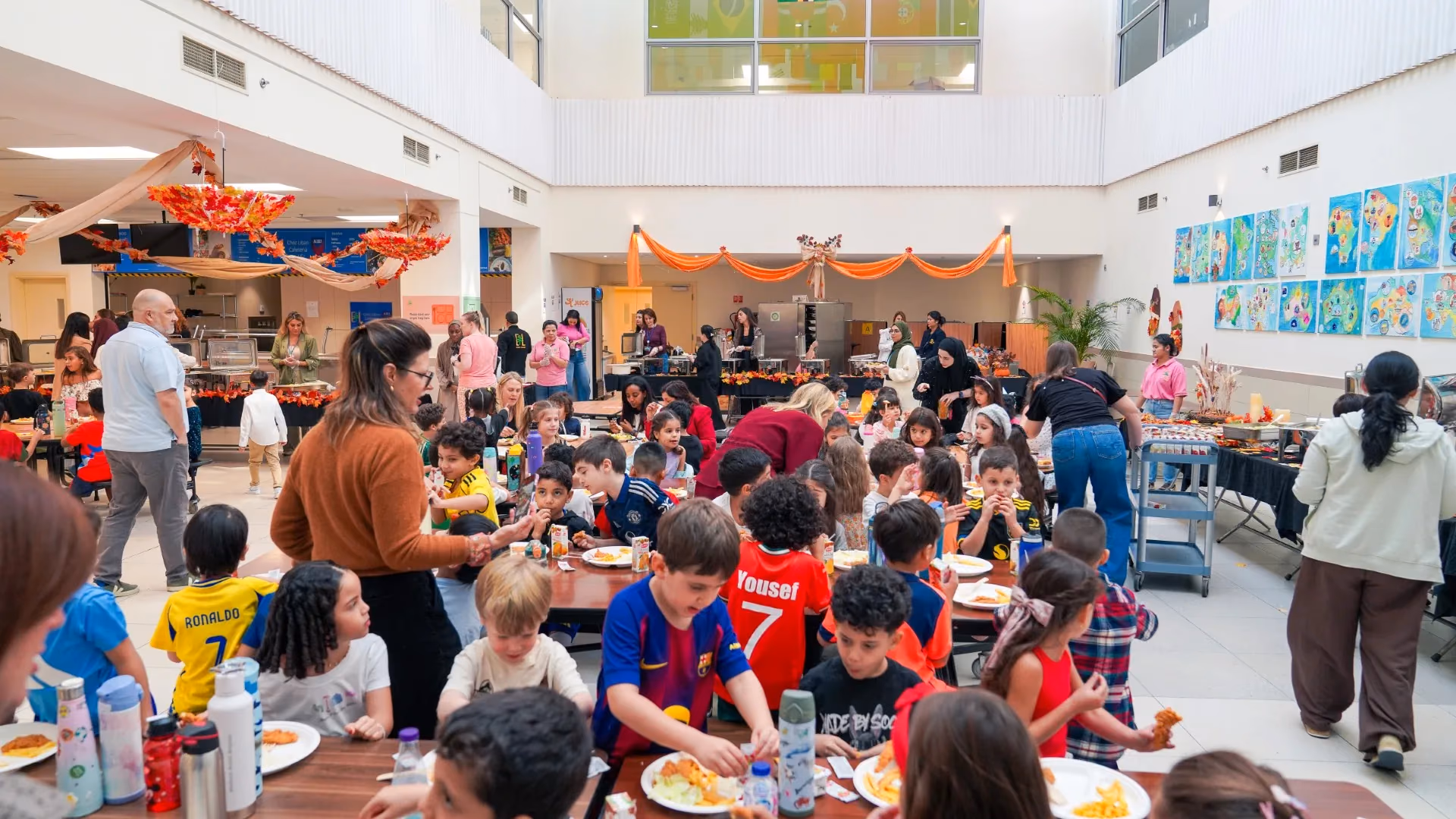 AISJ families and students gathered in a decorated campus community space