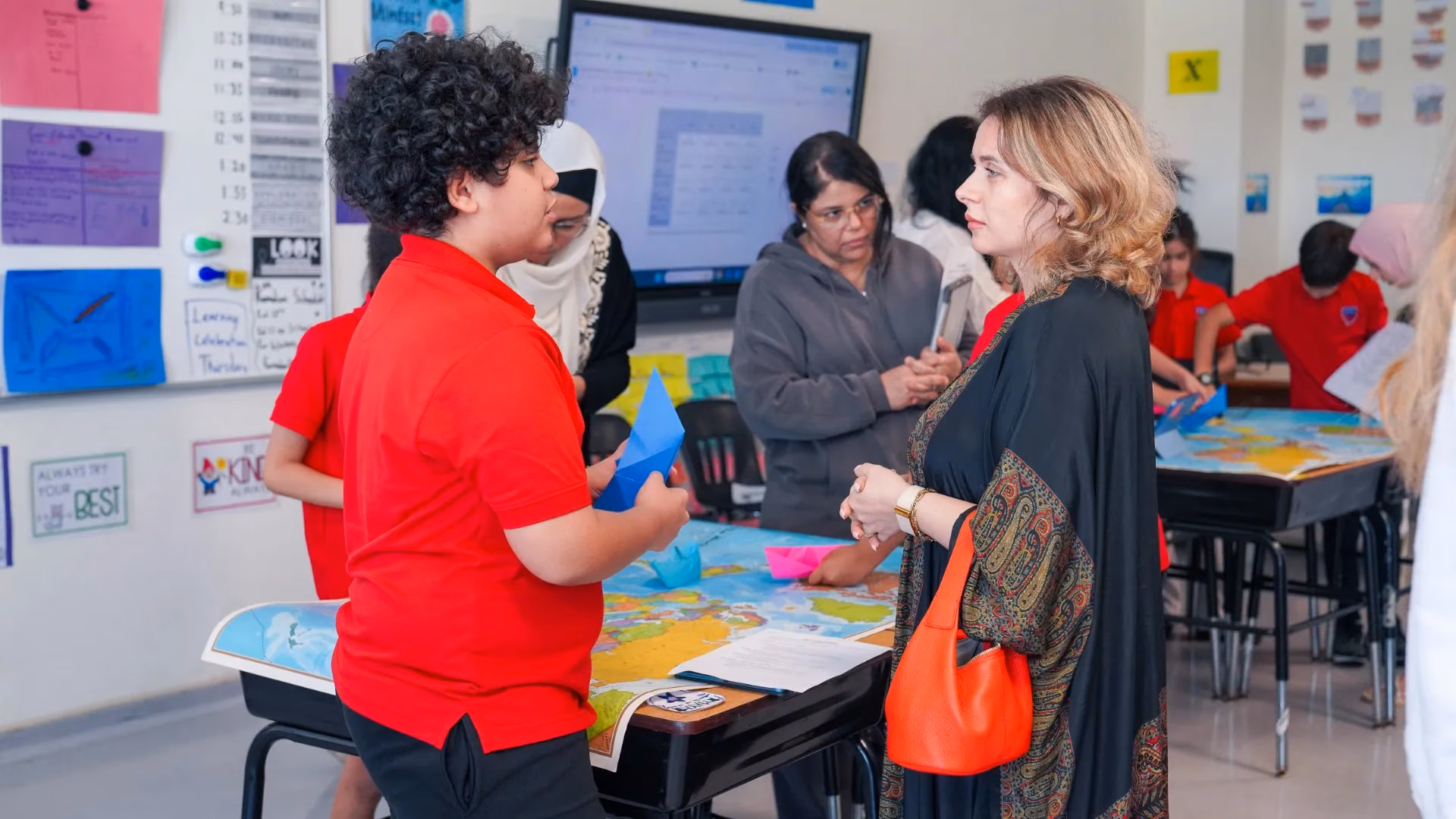 An AISJ teacher in conversation with elementary students