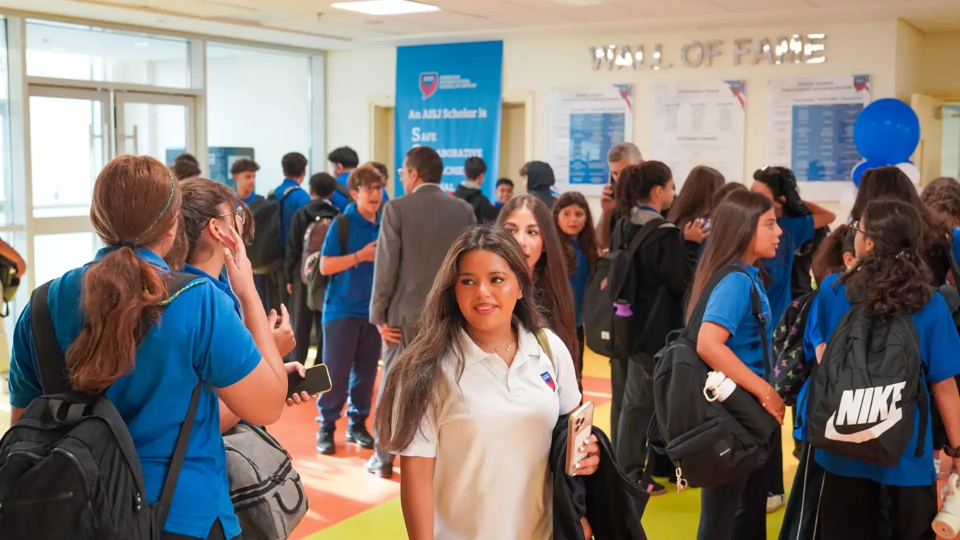 Students gathering in the AISJ arrival hall at the start of the school day